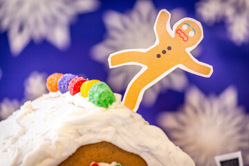 Funny Diorama of a Gingerbread Person Falling off of the Roof of a Gingerbread House