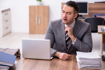 Young male employee working in the office