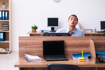 Young male employee in industrial espionage concept