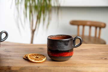 colorful handmade ceramic coffee cup on wooden table