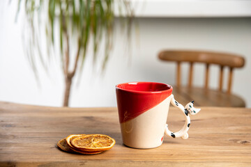 colorful handmade ceramic coffee cup on wooden table