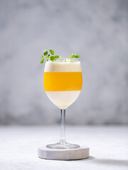 Italian dessert panna cotta with tangerine jelly layer in a glass