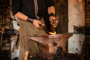 Detail shot of metal being worked at a blacksmith forge