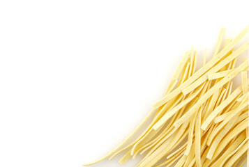 Raw food Italian Macaroni. Pasta on white background. Egg homemade dry ribbon noodles.  Close up. There is some free space for your text or sign.