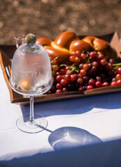 Holy grapes and bread on table outside