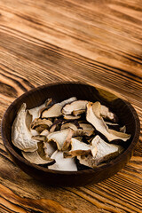 dry porcini mushrooms in a wooden bowl