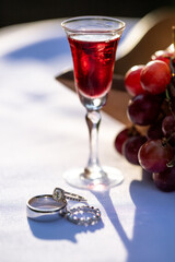 Red Wine and grapes on white tablecloth 