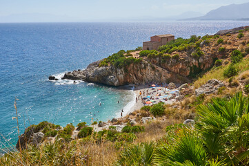 Obraz premium The paradise beach in Italy: perfect transparent turquoise water, white pebbles surrounded by greenery. 