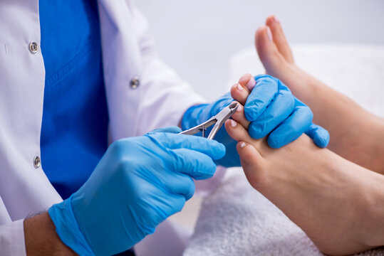 Podiatrist treating feet during procedure