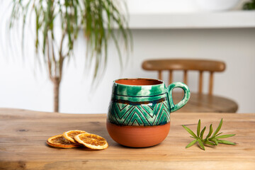 colorful handmade ceramic coffee cup on wooden table