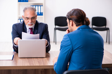 Young male candidate employee meeting with old recruiter