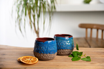 colorful handmade ceramic coffee cups on wooden table