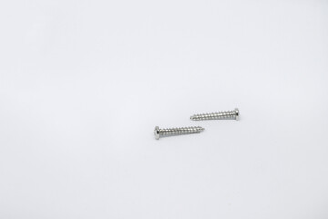 Photo shoot of screws on white background. Variety of screws. Product photos.