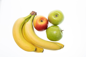 Banana with fresh red and green apples on white