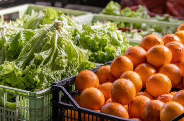 Oranges and lettuce at farmers market, for sale, fresh and healthy food.