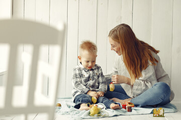 Preparing for Easter. Mother and son paint eggs. Family at home.