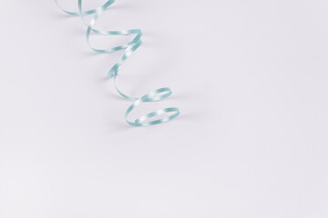 in the form of a snake folded blue ribbon on a white surface