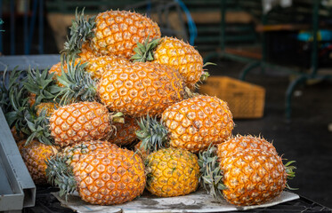 Pineapples on display at farmers market, fresh and healthy fruits.
