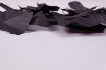 side view of scraps of black paper