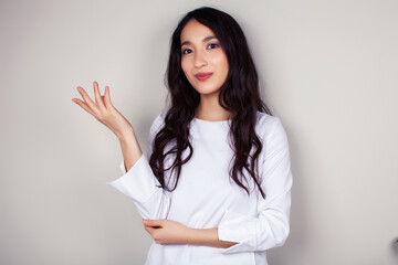 young asian woman doctor in white uniform gesturing positive on gray background, lifestyle healthcare people concept
