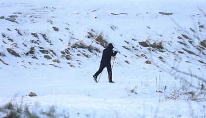 a man on cross-country skis somewhere on the trail near the Narew River in Poland