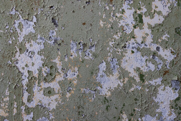 Peeling paint on the wall. Old concrete wall with cracked flaking paint. Weathered rough painted...