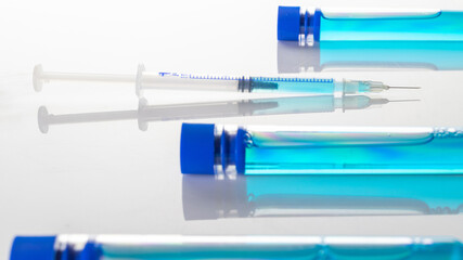 Vaccine vial. Medical syringe with needle for protection flu virus and coronavirus. Covid inoculation on white. Close up vaccine vial dose flu shot drug needle syringe.
