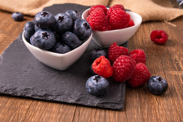 Raw organic blueberries in a heart bowl with strawberry jam