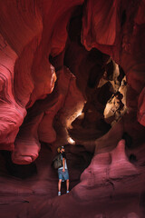 Tourist man adventurer standing in Coves De Can Riera caves in Torrelles, Barcelona, Catalonia,...