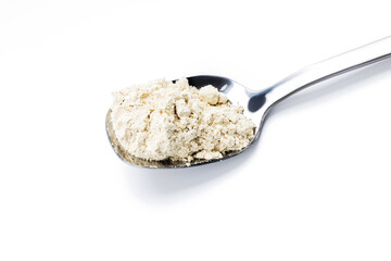dry wasabi powder on spoon isolated on a white background. above view