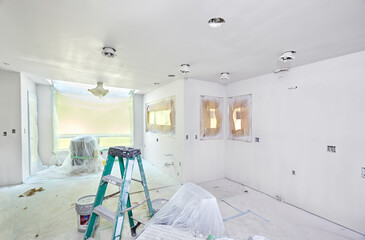 Kitchen wrapped and taped for spray painting the walls and ceiling
