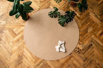 Jute Twine round Mat rug eco style with green plant. Knitted at home decoration concept. round...