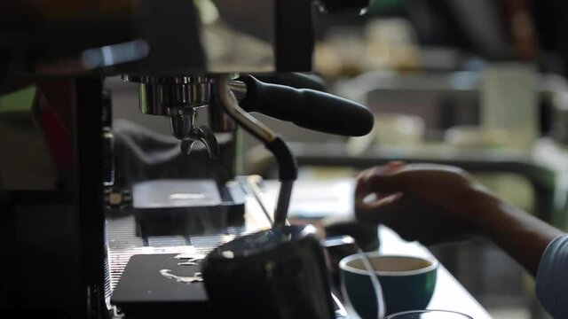 BARISTA MAKING COFFEE IN A RESTAURANT