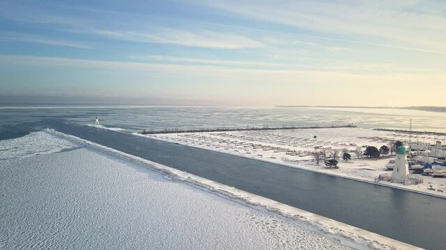 Pull-away aerial shot of lighthouses and pier at Port Dalhousie on Lake Ontario.