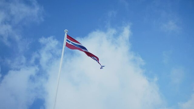Norwegian flag , winter clouds in Aalesund, Norway.