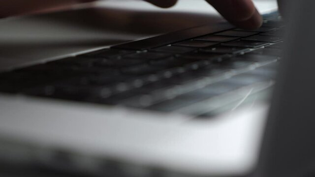 Man typing on laptop keybord, closeup
