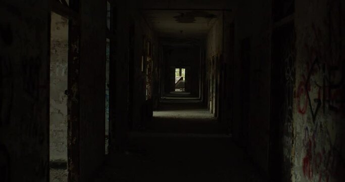 Walkthrough shot of an vandalized hallway in an abandoned building