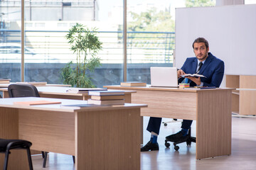 Young male teacher in suit in the classroom