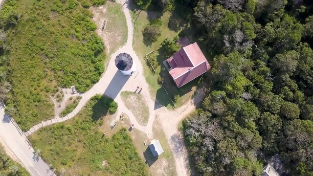 Top-down View Of Nauset Lighthouse With Cars Driving On Beach Road During Summer In Cape Cod, Eastham, Massachusetts. - aerial