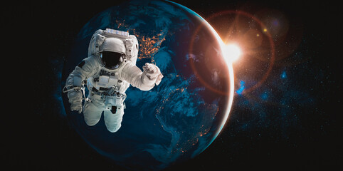 Naklejka na ściany i meble Astronaut spaceman do spacewalk while working for space station in outer space . Astronaut wear full spacesuit for space operation . Elements of this image furnished by NASA space astronaut photos.