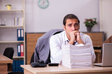 Naklejka premium Young male employee extremely tired with excessive work