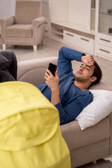 Young male contractor looking after baby at home