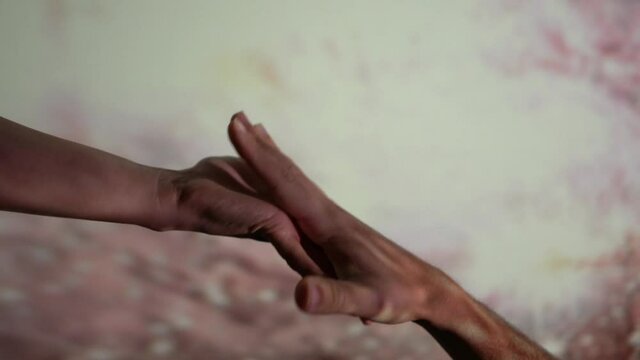 woman extends her hand to man in a lower position and they connect but then slips from her hand connection between people conceptual