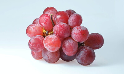 A large bunch of fresh grapes on a white background
