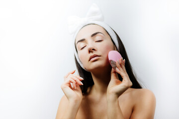 happy woman using deep cleansing face tool. Beautiful naked woman clean face with electric...