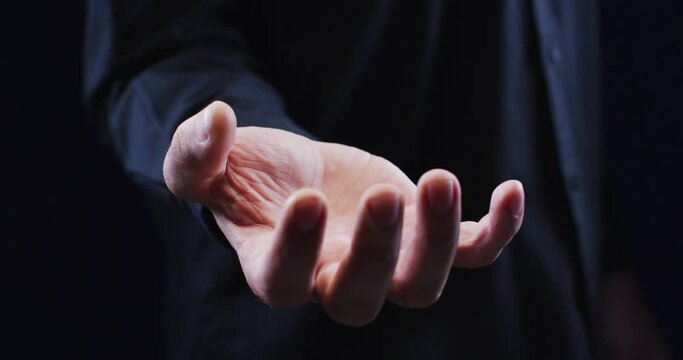 Hand of a caucasian man palm up holding an unseen object