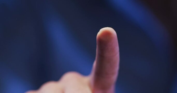 Index finger of caucasian man using digital interface applying fingerprint to touchscreen