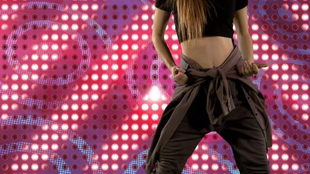 Animation of mid section of caucasian woman dancing over glowing pink pattern background
