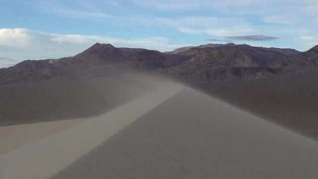 Sand blowing up and over a steep ridge in the sand dune, , Eureka Dunes, Death Valley National Park