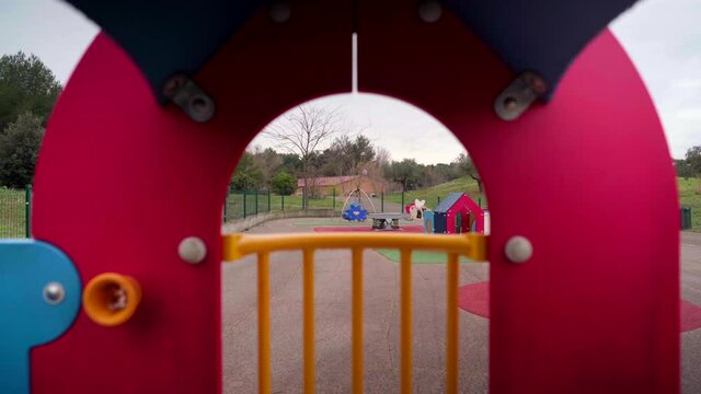 Empty playground during Covid-19 coronavirus pandemic lockdown, view through a cubby house